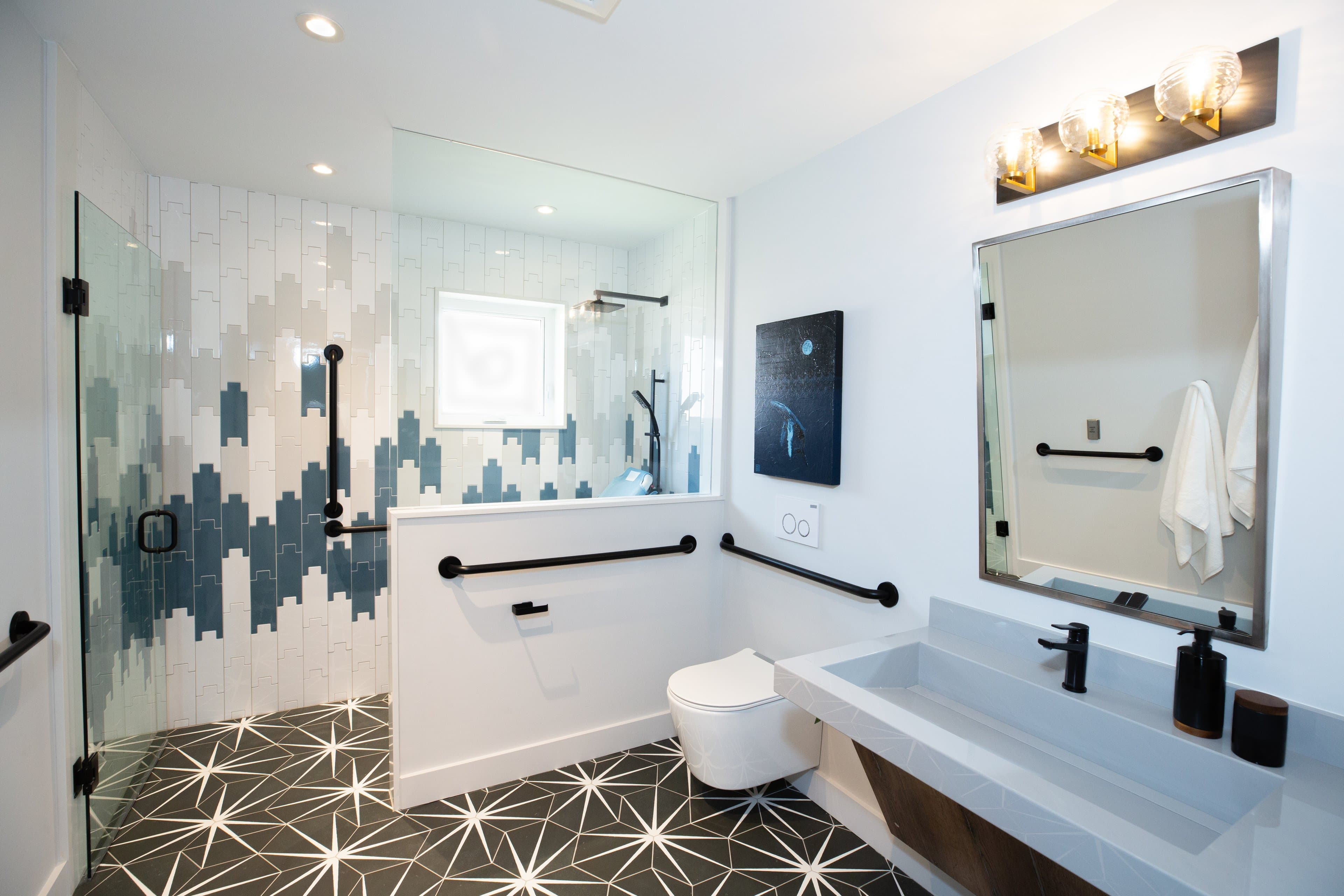 Modern bathroom with geometric tile design and stylish black fixtures